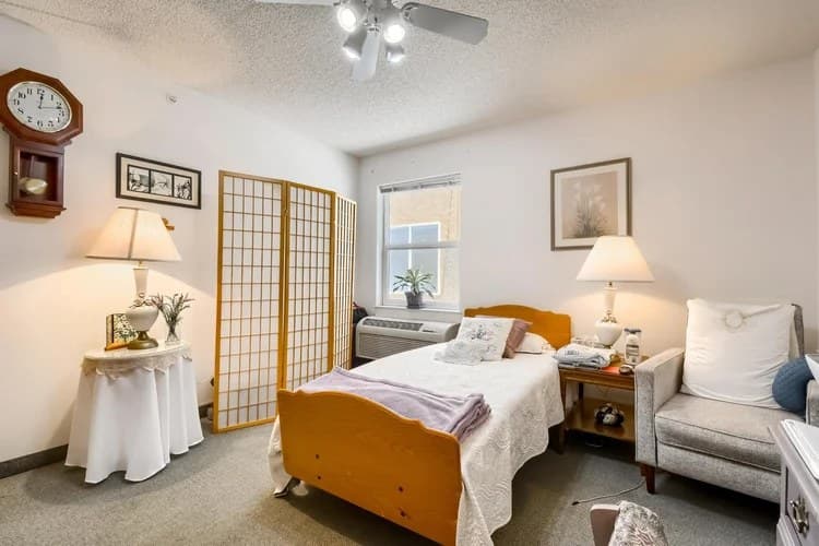 Private resident bedroom with ceiling fan and personal touches at Aspen Leaf 6th Street