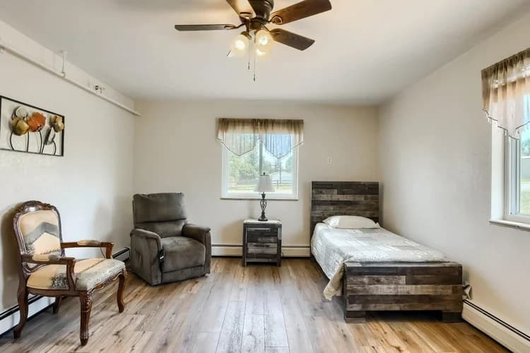 Spacious resident room with seating and a rustic bed frame at Aspen Leaf Circle Lane
