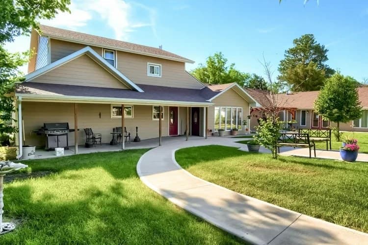 Aspen Leaf Flagler exterior with covered patio, barbecue area, and landscaped lawn