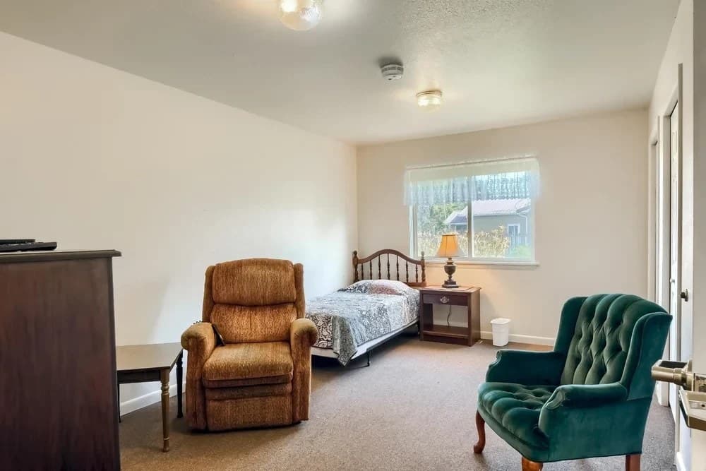 Spacious resident room with comfortable seating and natural light at Aspen Leaf Stratton