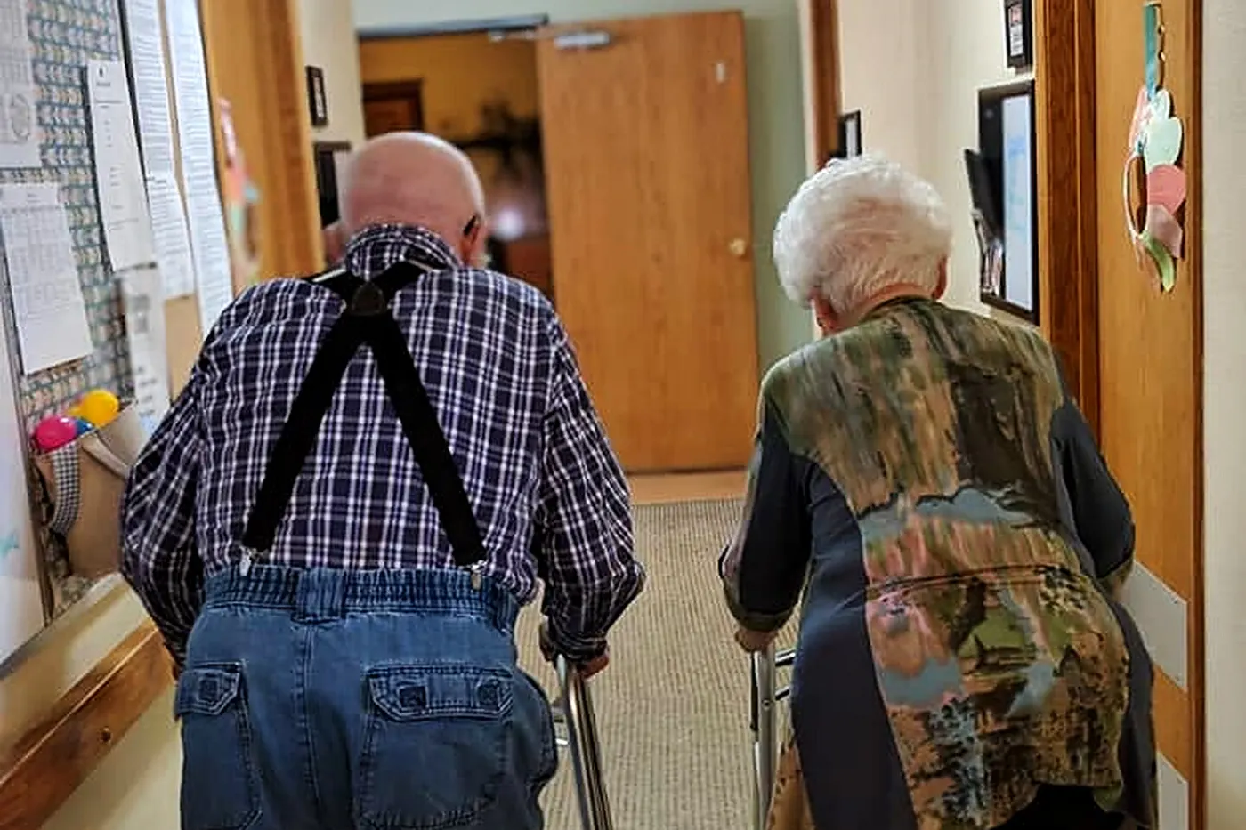 Two residents walking together down a hallway at an Aspen Leaf home in Eastern Colorado